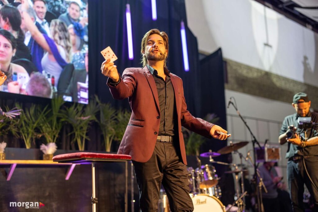 Alex Boyer performs a card trick at a corporate event.